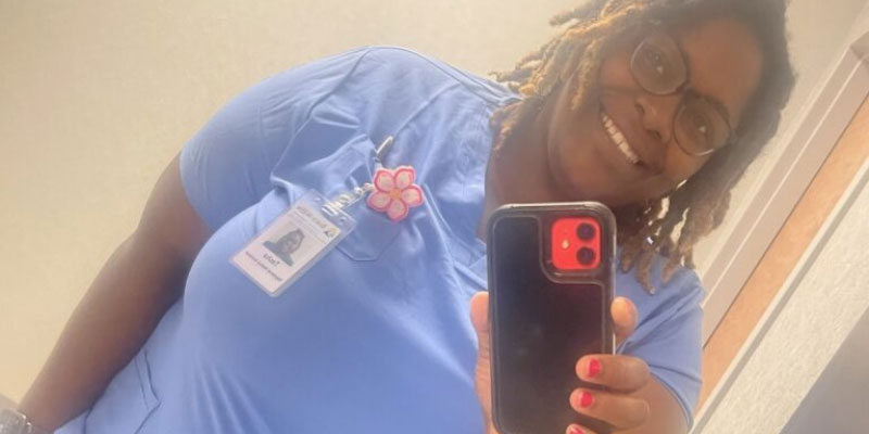 Natasha in her scrubs at work as a medical assistant